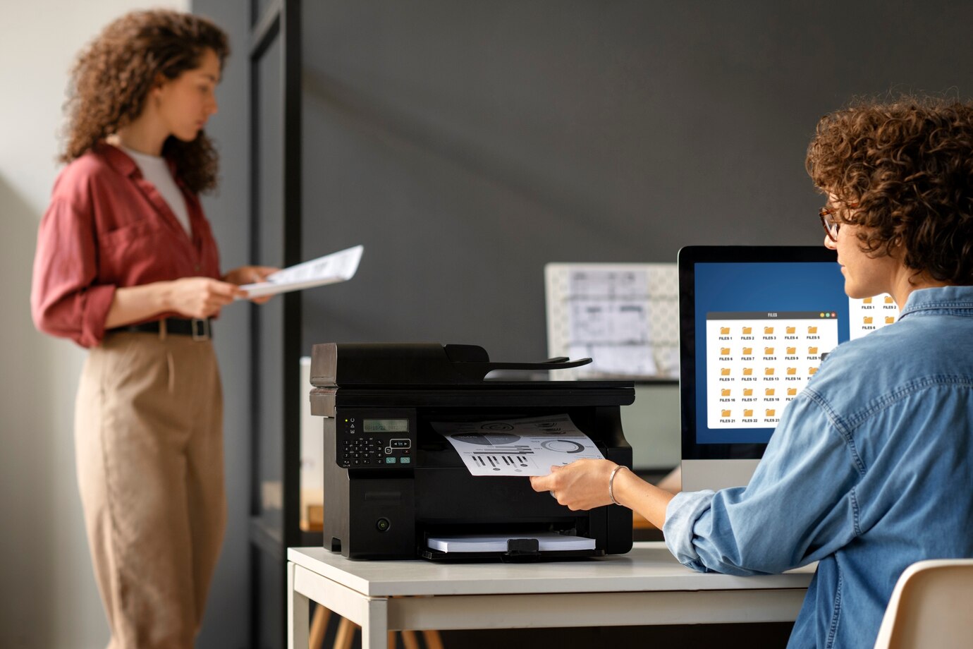 Woman using an HP printer in an office in Dubai